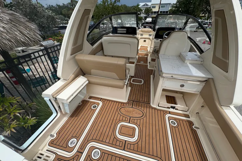 Slide: The Image of 2022 Scout 277 Dorado boat interior with teak flooring and beige seating. - 25