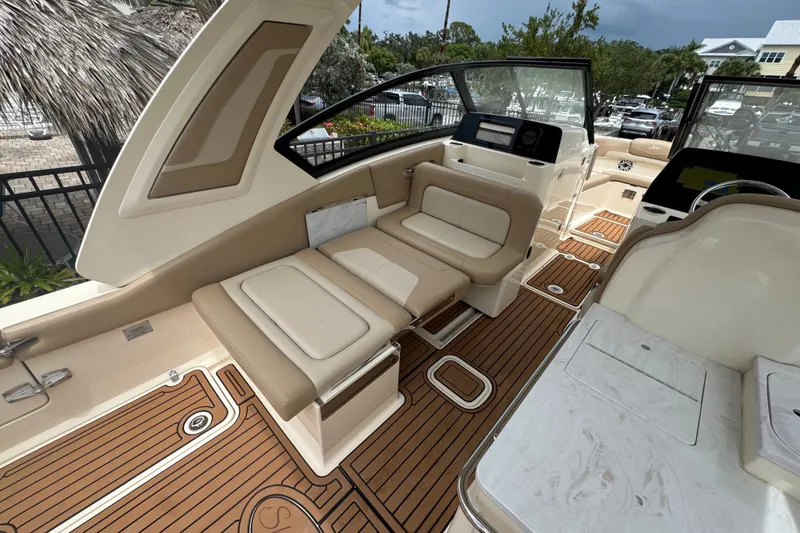 Slide: The Image of 2022 Scout 277 Dorado boat interior with beige seating and teak flooring. - 20