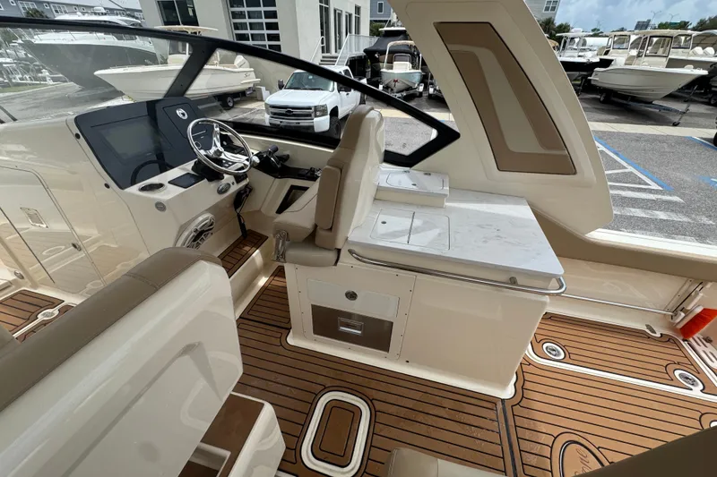 Slide: The Image of 2022 Scout 277 Dorado boat interior with modern helm and seating area. - 21
