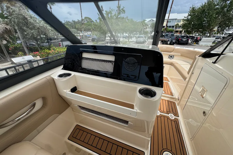 Slide: The Image of Interior view of 2022 Scout 277 Dorado boat, featuring luxurious seating and modern dashboard. - 33