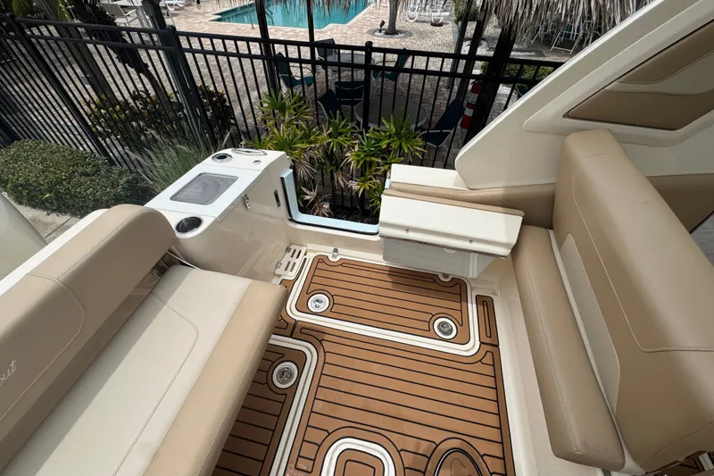 Slide: The Image of 2022 Scout 277 Dorado boat interior with tan seating and teak-style flooring. - 24
