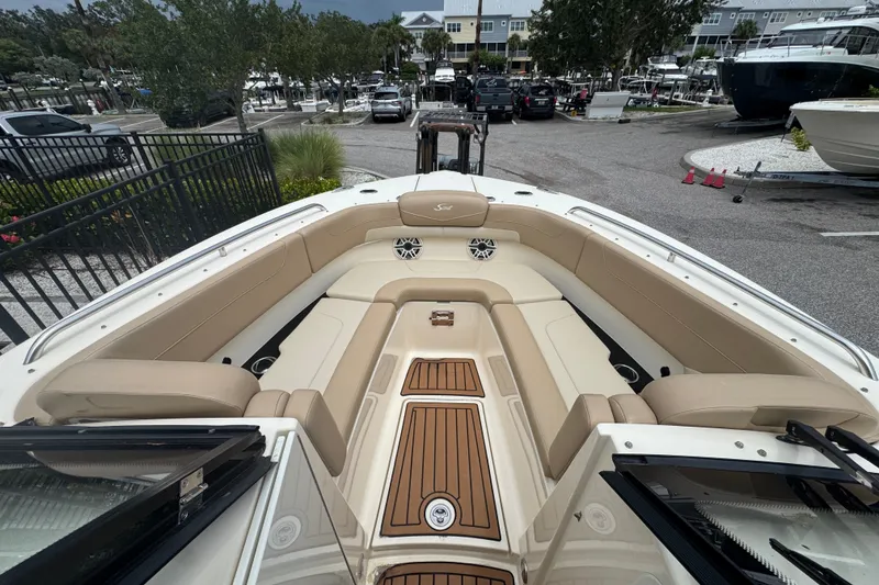 Slide: The Image of 2022 Scout 277 Dorado boat interior with beige seating and wood accents. - 15