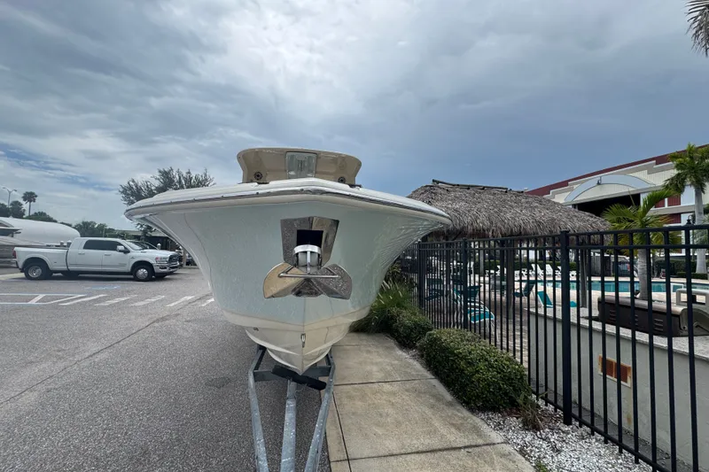 Slide: The Image of 2022 Scout 277 Dorado boat on trailer, parked near a poolside area. - 7