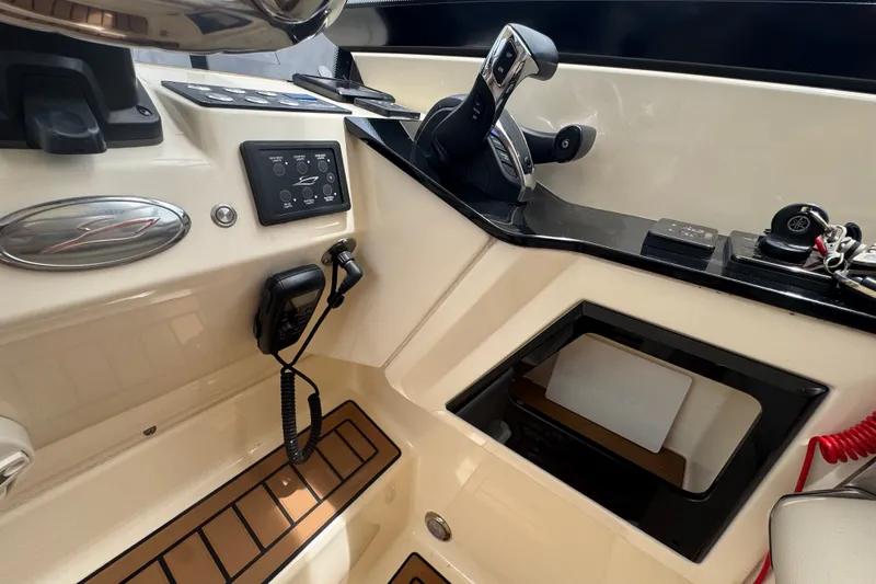 Slide: The Image of 2022 Scout 277 Dorado boat dashboard with controls and steering wheel. - 29