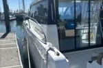 Slide: The Image of 2016 Jeanneau Velasco 37F docked at marina, side view with reflections on windows. - 15
