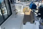 Slide: The Image of 2016 Jeanneau Velasco 37F yacht deck with seating and marina view. - 13
