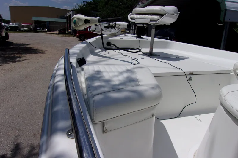 Slide: The Image of 2004 Sea Pro SV1900CC Bay Boat with white seating and trolling motor. - 8