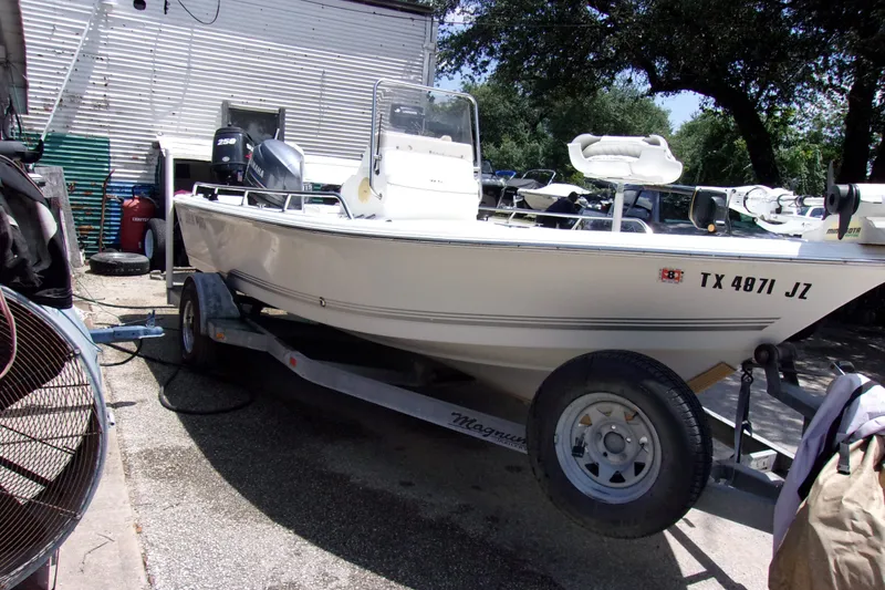 Slide: The Image of 2004 Sea Pro SV1900CC Bay Boat on trailer, parked outdoors. - 2