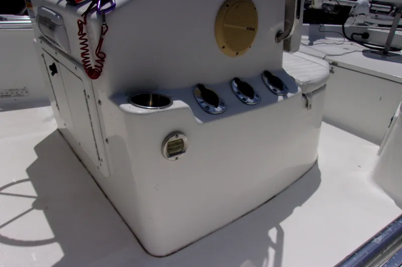 Slide: The Image of 2004 Sea Pro SV1900CC Bay Boat console with cup holders and storage compartments. - 10