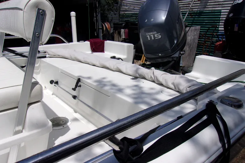 Slide: The Image of 2004 Sea Pro SV1900CC Bay Boat interior with Yamaha 115 engine, featuring seating and storage. - 12