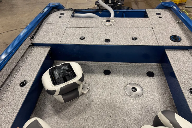 Slide: The Image of Interior of a 2023 Polar Kraft Outlander 2010 WT boat, featuring seating and storage compartments. - 9