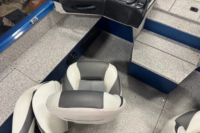 Slide: The Image of Interior of a 2023 Polar Kraft Outlander 2010 WT boat with gray seating and flooring. - 8