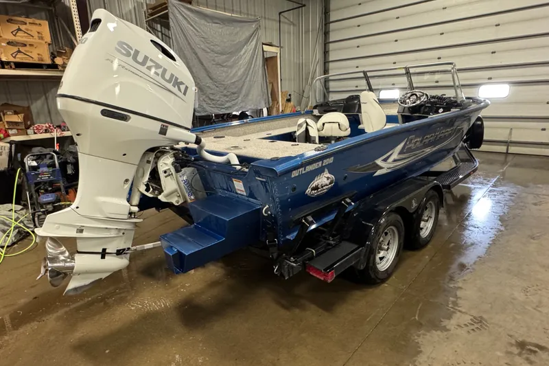 Slide: The Image of Polar Kraft Outlander 2010 WT boat with Suzuki engine in a garage, 2023 model. - 3