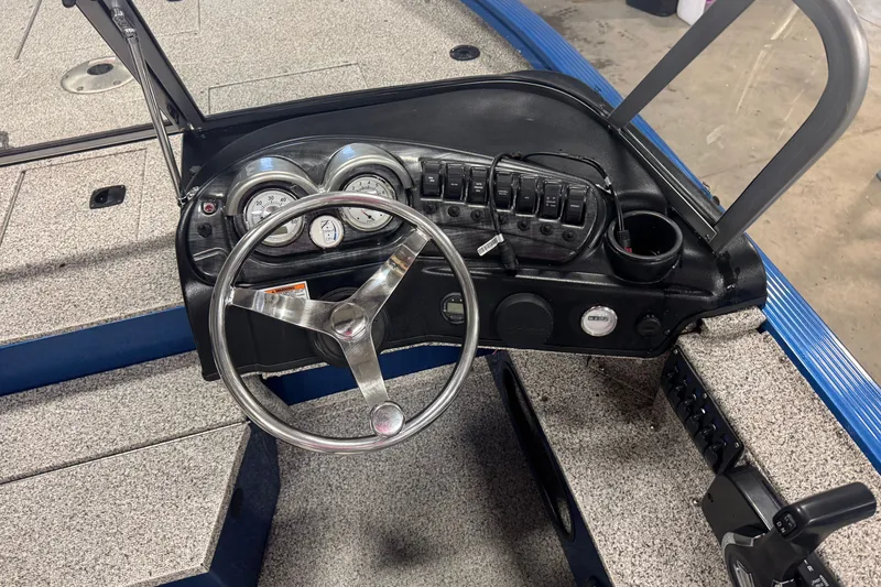 Slide: The Image of Steering console of a 2023 Polar Kraft Outlander 2010 WT boat with gauges and controls. - 6