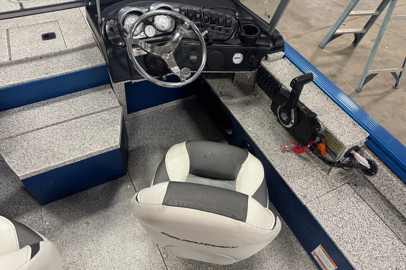 Slide: The Image of Interior of a 2023 Polar Kraft Outlander 2010 WT boat, featuring steering wheel and seating. - 5