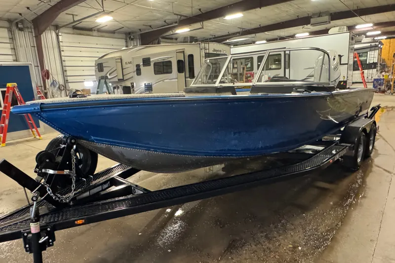 Slide: The Image of 2023 Polar Kraft Outlander 2010 WT boat on trailer in indoor storage facility. - 1