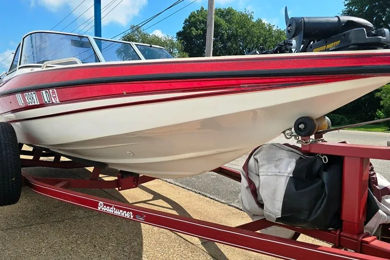 Slide: The Image of 1997 Cajun 1700 Fish and Ski boat on a red trailer, parked outdoors. - 14