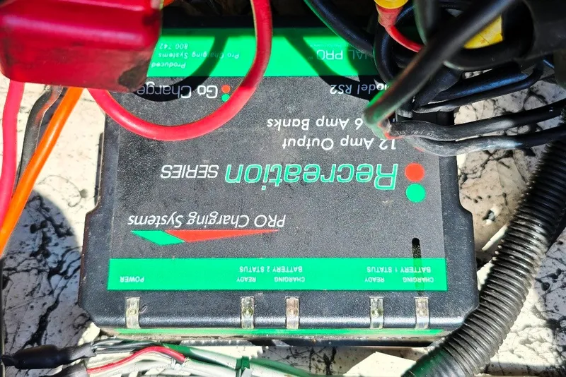 Slide: The Image of Battery charger with cables on a 1997 Cajun 1700 Fish and Ski boat. - 19