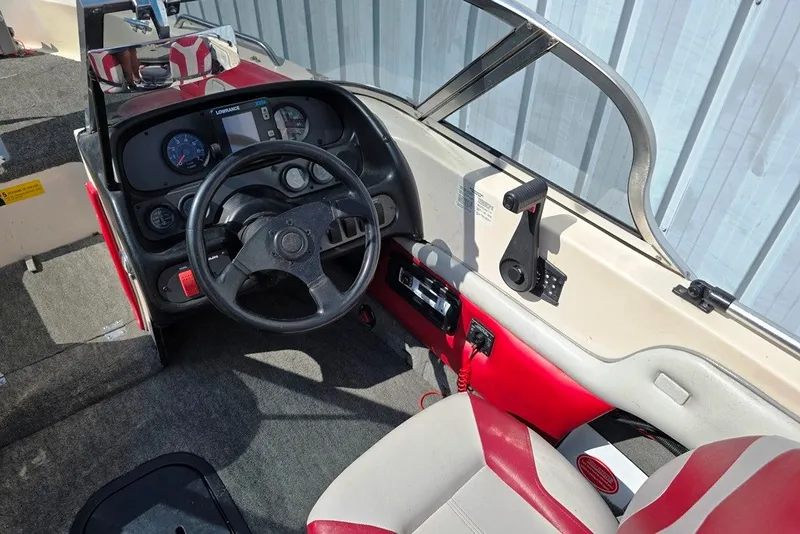 Slide: The Image of Interior of a 1997 Cajun 1700 Fish and Ski boat, featuring steering wheel and dashboard controls. - 3