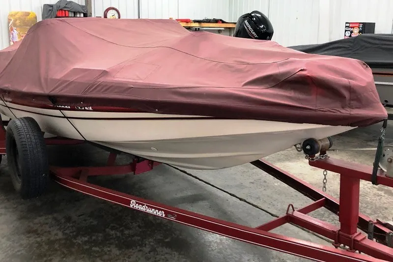 Slide: The Image of 1997 Cajun 1700 Fish and Ski boat covered on trailer in garage. - 20