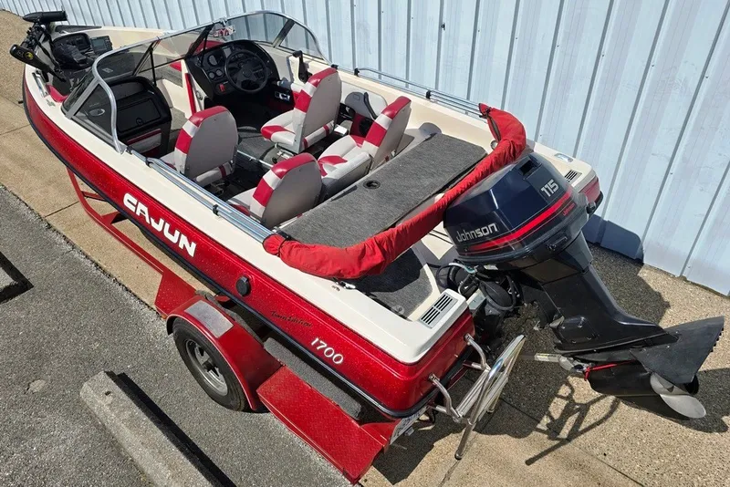 Slide: The Image of 1997 Cajun 1700 Fish and Ski boat with Johnson 115 outboard motor, red and white design. - 2