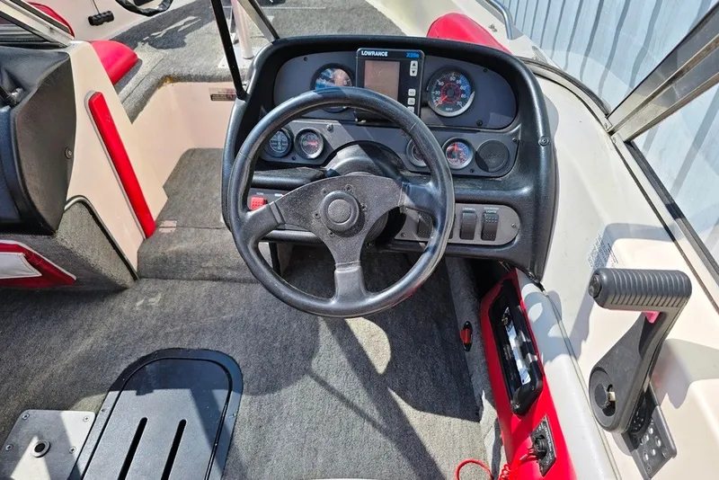 Slide: The Image of 1997 Cajun 1700 Fish and Ski boat dashboard with steering wheel and instrument panel. - 16