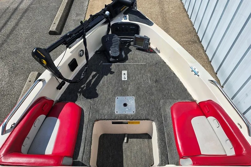 Slide: The Image of 1997 Cajun 1700 Fish and Ski boat interior with red seats and fishing equipment. - 6