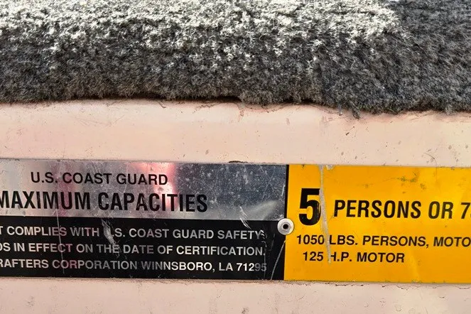 Slide: The Image of 1997 Cajun 1700 Fish and Ski boat capacity label, 5 persons or 1050 lbs, 125 HP motor. - 21