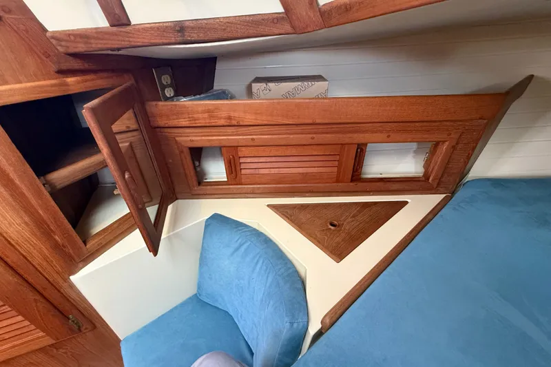 Slide: The Image of Interior of 1994 Pacific Seacraft Crealock 37 with wooden cabinetry and blue upholstery. - 43