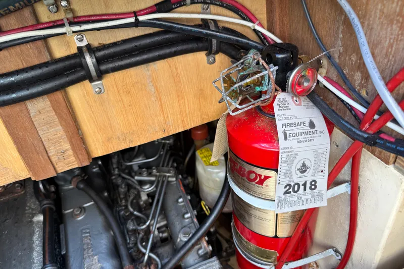 Slide: The Image of Fire extinguisher and engine wiring in 1994 Pacific Seacraft Crealock 37 sailboat. - 84
