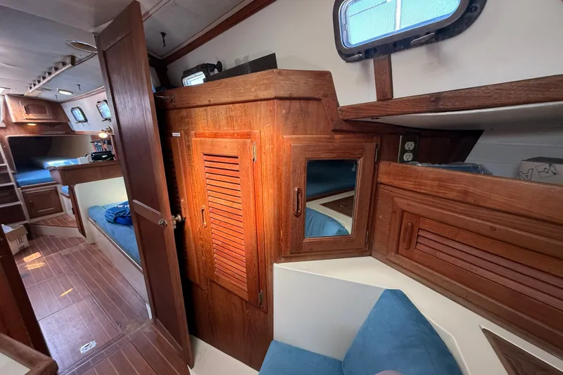 Slide: The Image of Interior of 1994 Pacific Seacraft Crealock 37 sailboat with wooden cabinetry and blue seating. - 41