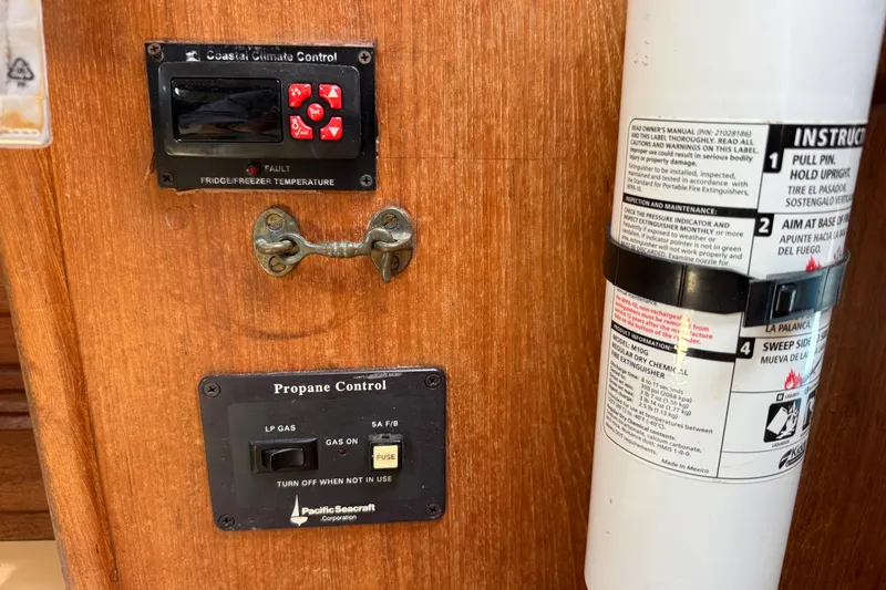 Slide: The Image of Control panel and fire extinguisher on a 1994 Pacific Seacraft Crealock 37 yacht. - 35