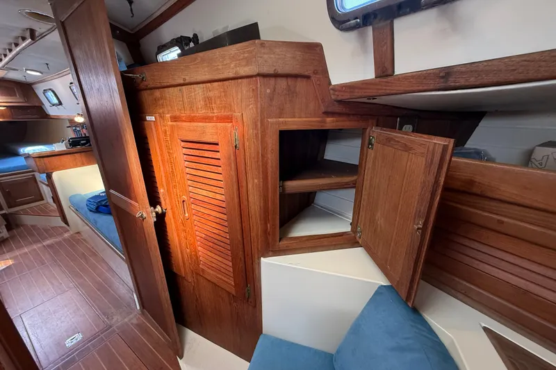 Slide: The Image of Interior of 1994 Pacific Seacraft Crealock 37 sailboat with wooden cabinetry and cozy seating. - 42