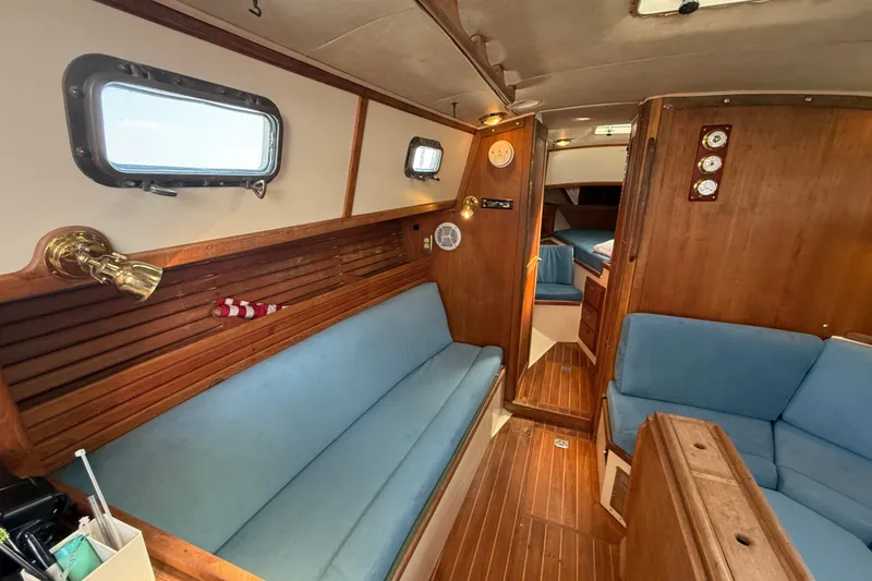 Slide: The Image of Interior of 1994 Pacific Seacraft Crealock 37 sailboat with blue seating and wooden finishes. - 15