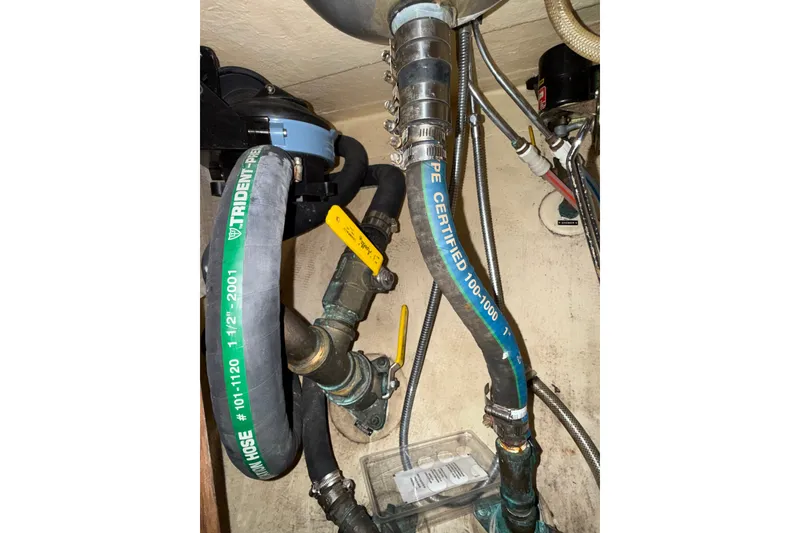 Slide: The Image of Plumbing system inside 1994 Pacific Seacraft Crealock 37, featuring hoses and valves. - 51