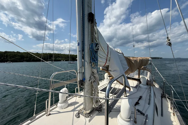 Slide: The Image of Sailboat deck view of 1994 Pacific Seacraft Crealock 37 under a partly cloudy sky. - 61