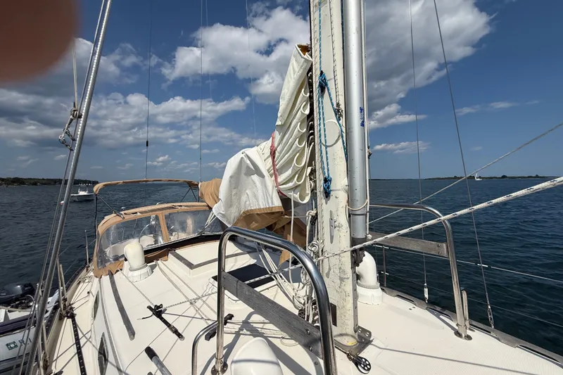 Slide: The Image of Sailboat deck view of 1994 Pacific Seacraft Crealock 37 under a partly cloudy sky. - 60