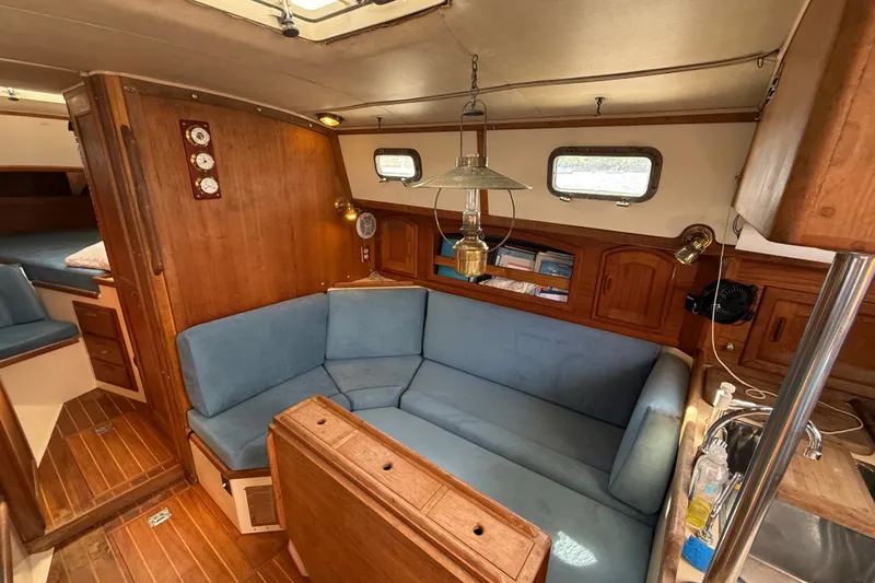 Slide: The Image of Interior of 1994 Pacific Seacraft Crealock 37 sailboat with cozy seating and wooden accents. - 14