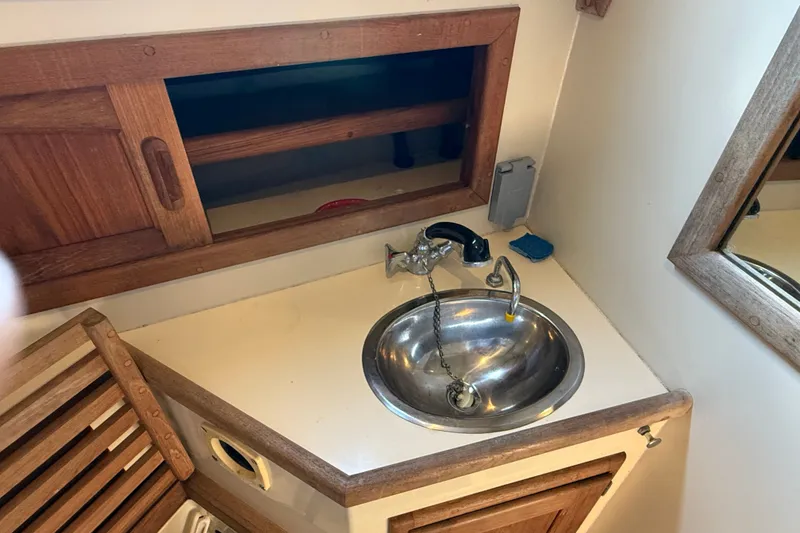 Slide: The Image of Interior of 1994 Pacific Seacraft Crealock 37 with sink and wooden cabinetry. - 50