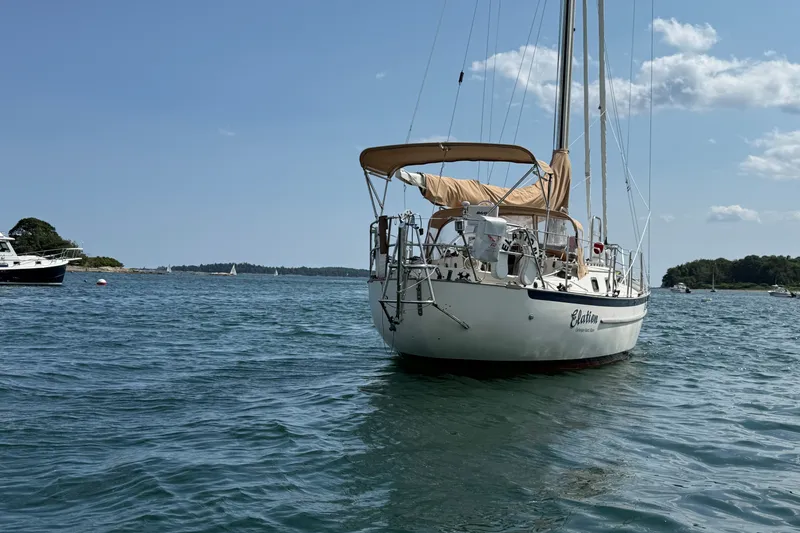 Slide: The Image of Sailboat "Pacific Seacraft Crealock 37" from 1994 anchored in a scenic bay. - 9