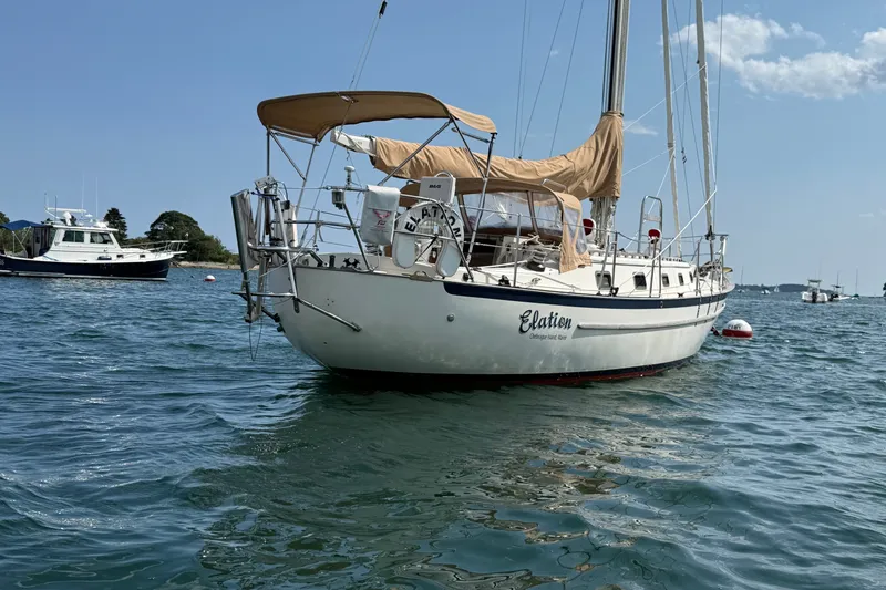 Slide: The Image of 1994 Pacific Seacraft Crealock 37 sailboat named "Elation" anchored in calm waters. - 10
