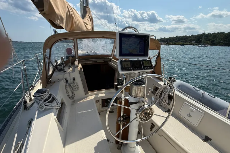 Slide: The Image of 1994 Pacific Seacraft Crealock 37 sailboat cockpit with steering wheel and navigation equipment. - 67