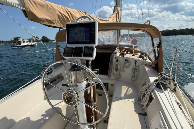 Slide: The Image of Cockpit of 1994 Pacific Seacraft Crealock 37 sailboat with navigation equipment and steering wheel. - 66