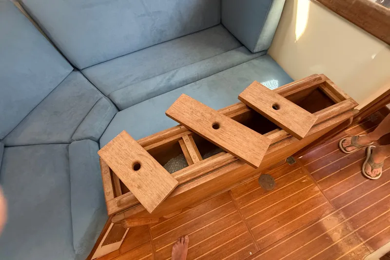 Slide: The Image of Interior of 1994 Pacific Seacraft Crealock 37 with wooden storage compartment and blue seating. - 17