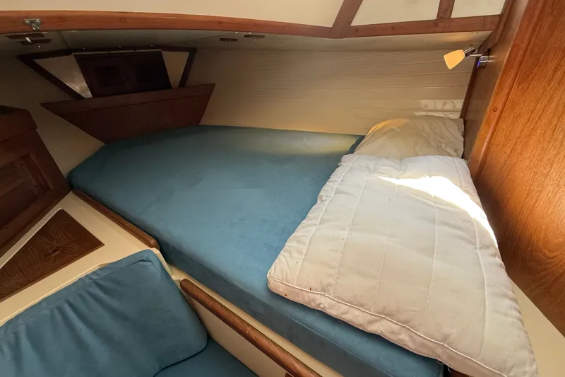 Slide: The Image of Cozy cabin interior of 1994 Pacific Seacraft Crealock 37 sailboat with blue bedding. - 39