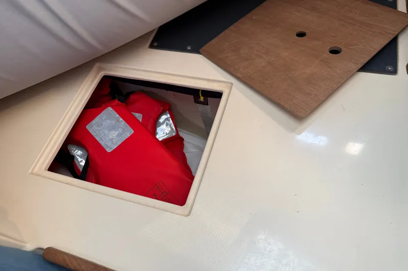 Slide: The Image of Red life jacket stored in a compartment on a 1994 Pacific Seacraft Crealock 37 sailboat. - 45
