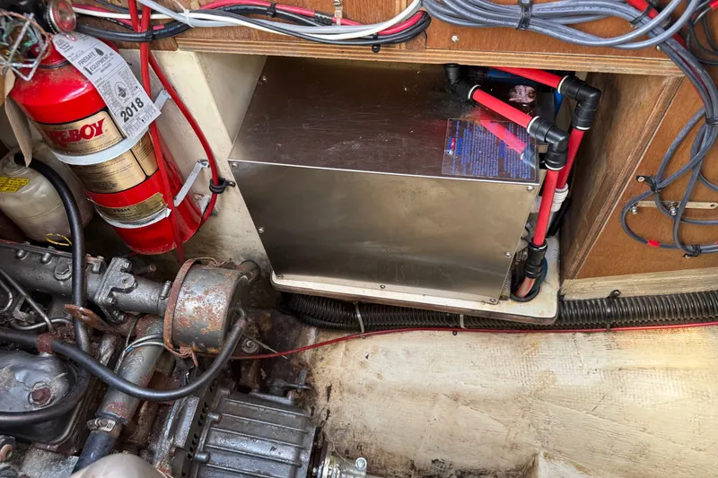 Slide: The Image of Engine compartment of a 1994 Pacific Seacraft Crealock 37 with fire extinguisher and wiring. - 81