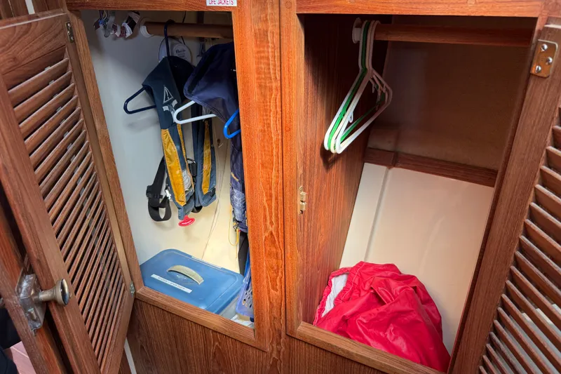 Slide: The Image of Wooden closet on 1994 Pacific Seacraft Crealock 37, storing life jackets and hangers. - 44