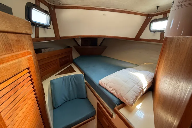 Slide: The Image of Cozy cabin interior of 1994 Pacific Seacraft Crealock 37 sailboat with wooden accents. - 38