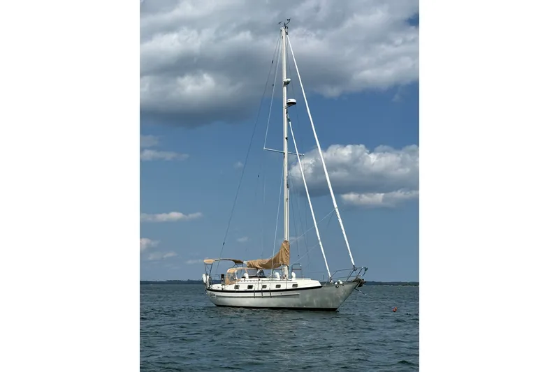 Slide: The Image of Sailboat on water, 1994 Pacific Seacraft Crealock 37, under a partly cloudy sky. - 3
